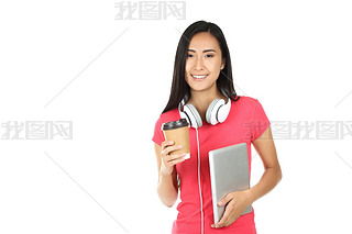 Young woman with tablet pc, headphones and paper cup on white ba