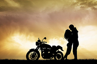 couple kissing on motorcycle