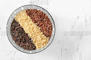 Bowl of white, red and black cooked quinoa