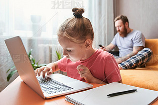 Child is sitting at desk and doing homework