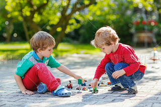 Two little boys playing with car toys