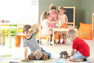 Cute little children playing in kindergarten