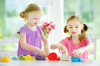 sisters  with colorful modeling clay  