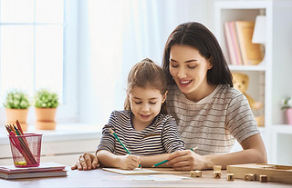 woman teaches child the alphabet