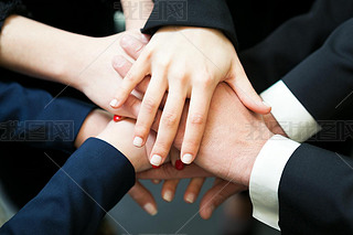 Closeup of pile of hands of business partners