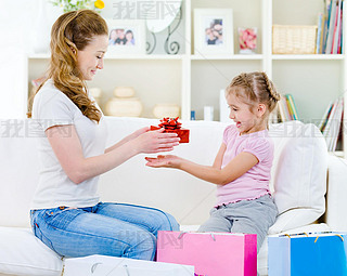 Mother giving a gift for her daughter