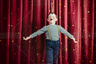 Boy Dressed as Clown Performing on Stage