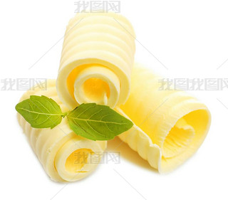 Curls of fresh butter with basil, isolated on white