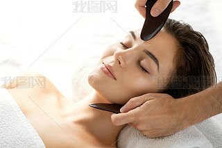 Woman during Chinese traditional massage - Gua Sha