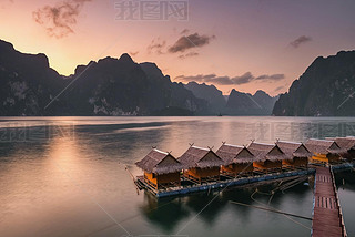 Beautiful sunset over the raft houses on Cheow Lan lake, Thailand. 