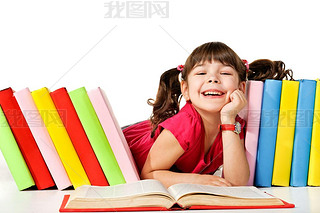 Happy little girl reading a book on the floor