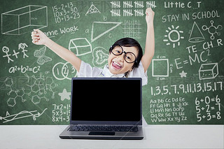 Kid celebrate her achievement with laptop in class