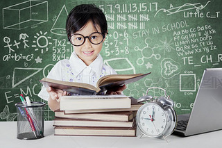 Kid reading books with clock on the table