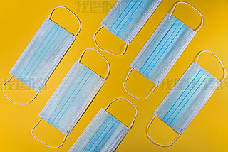 Surgical face masks on yellow background. Medical mask for Covid-19 protection to prevent coroniru
