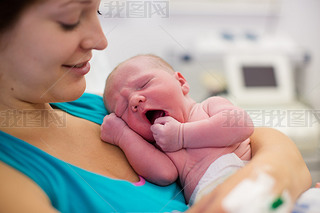 Young mother giving birth to a baby