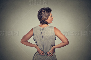 young woman standing with backache back pain