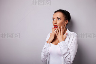 Cheerful young woman is shocked and terrified