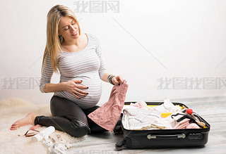 Woman packing baby clothes