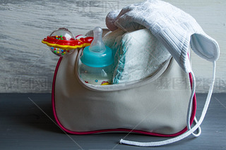 Womens handbag with items to care for the baby