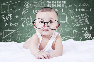 Funny baby with glasses and a doodles background