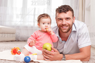 Father and little kid sitting on floor