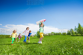 Children run after boy holding rocket