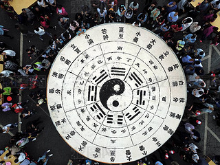 Tourists share 3.5 tons of tofu in the shape of a Tai Chi diagram during a Taoist festival at the La