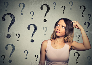 Thinking young woman with looking up at many questions marks