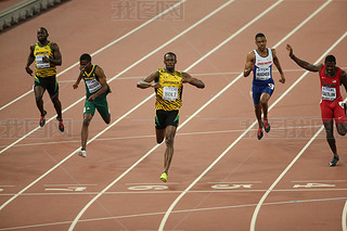 Usain Bolt of Jamaica, center, crosses the finish line to win the men's 200m final during the Beijin