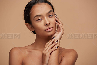 Charming mixed race girl, looking gently and tenderly like in the mirror, after a face care mask, he