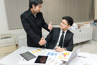 Two Asian businesen success concept,Thailand employee happy from work finished,Shaking hands after