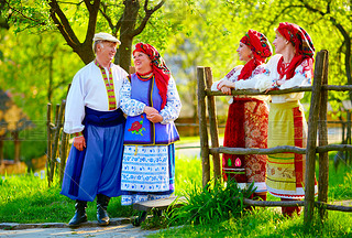 happy ukrainian family, dressed in national costumes, talking on the street