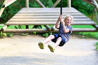 Happy boy hing fun at playground