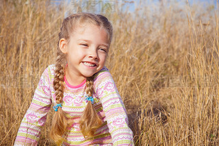 Portrait of a girl with pigtails closeup outdoors