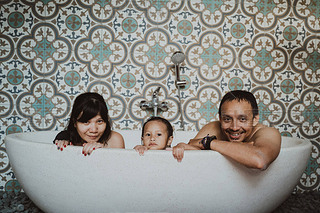 hing fun together young family when playing on the bathtub