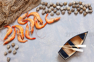 Fresh raw Surf clam chamelea gallina, shrimps, fishing boat with oars and  fishnet. Top view, close 