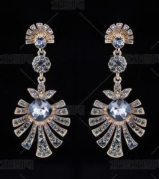 gold earrings with jewels on the black