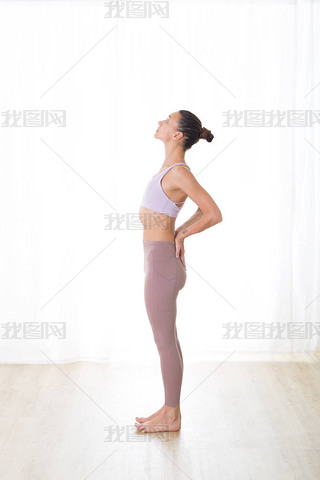 Portrait of gorgeous active sporty young woman practicing yoga in studio. Beautiful girl practice Ar