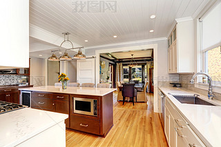 White interior of kitchen room with large kitchen island.