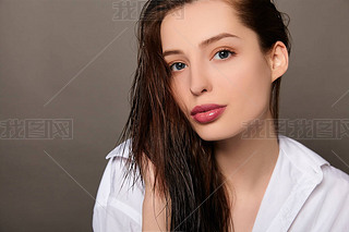 Close-up of a young white lady with loose wet hair.