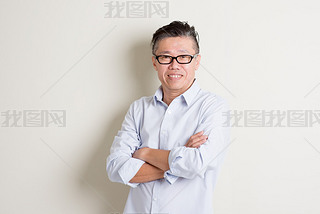 Portrait of mature Asian male arms crossed