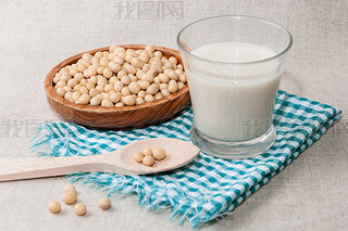 Glass of milk and bowl with soy