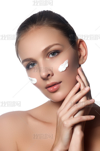 Skin care lady putting face cream. Attractive brunette girl on white background. Beautiful face of y