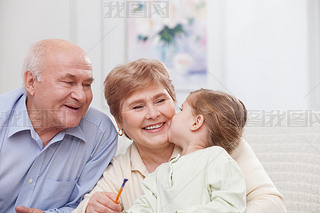 Pretty grandparents are taking care of child