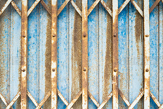 steel folding door Blue sliding exterior with steel plate lock and thick steel door inside, rusty st