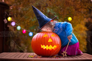 Kids carving pumpkin at Halloween