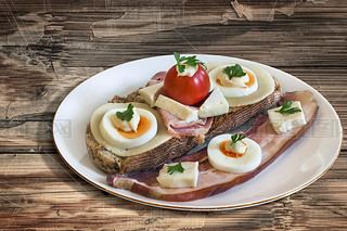 Bacon Cheese Egg Ham and Tomato Sandwich on old Wooden Table