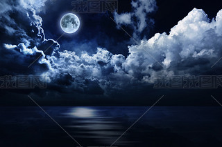 Full moon in night sky over water