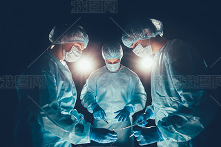 Medical team  hospital performing operation. Group of surgeon at work in operating theatre room. hea