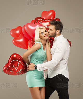 Kissing couple with red balloons